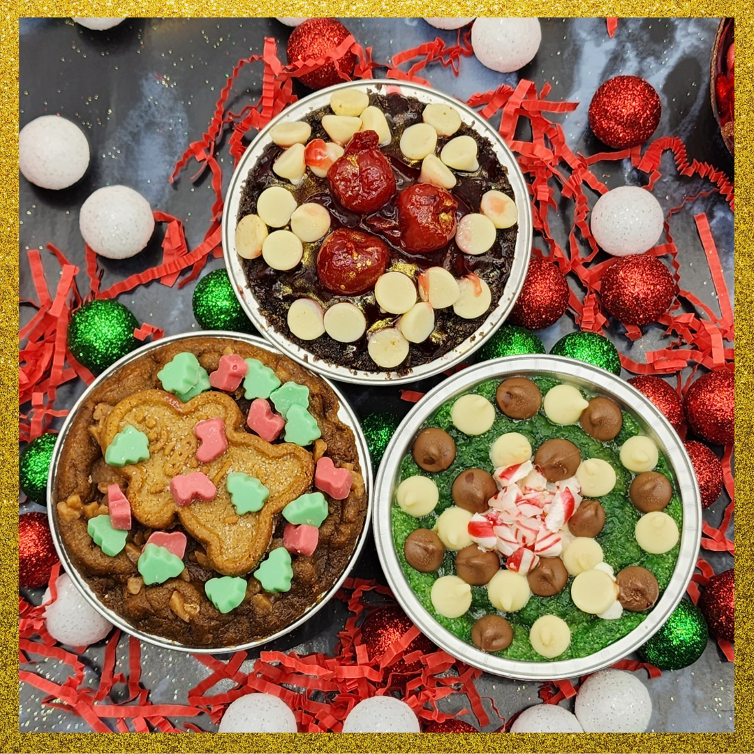 Three festive cookie tins with various toppings stuffed and goey skillet cookies